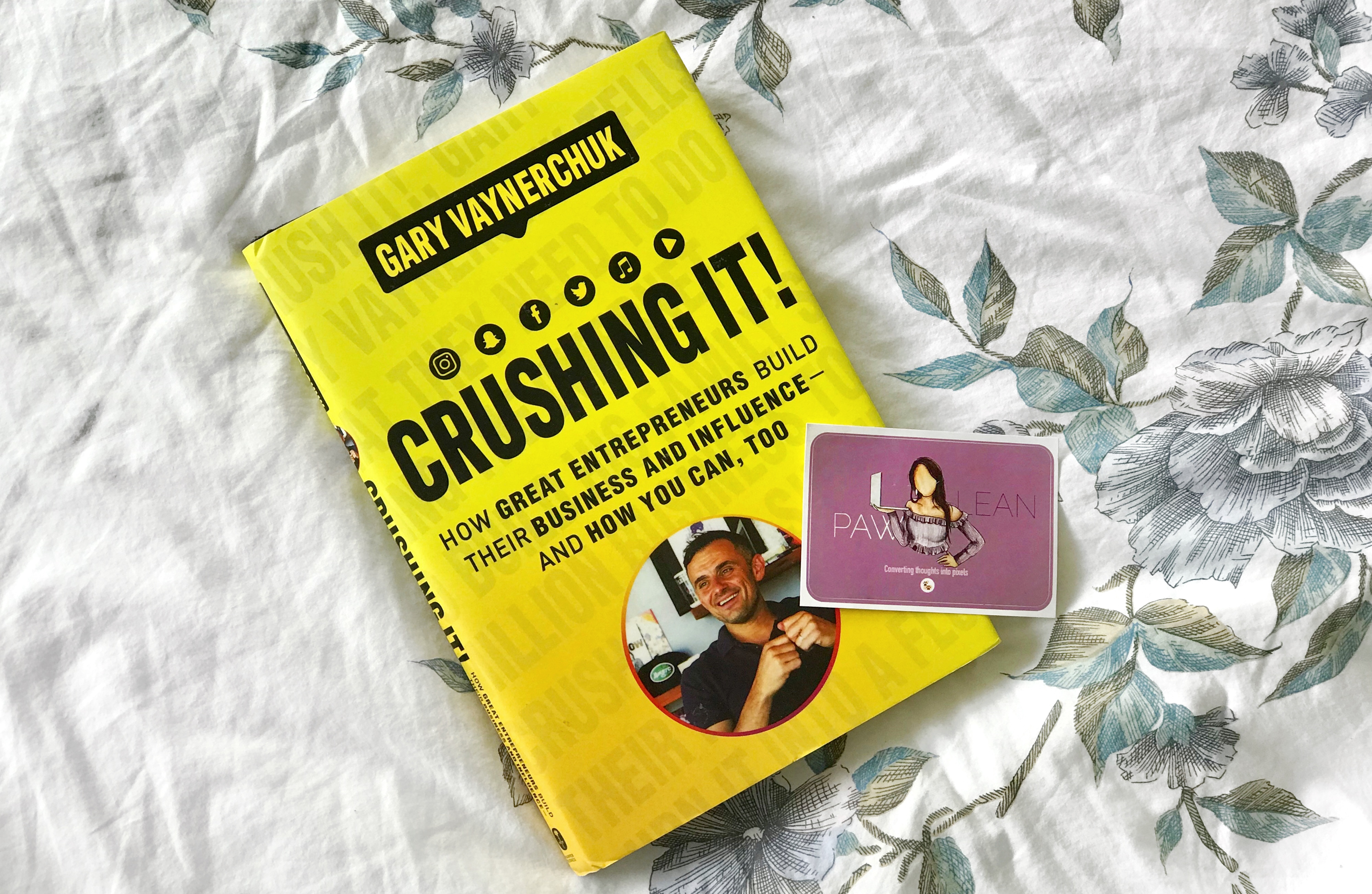 A picture of Gary Vaynerchuk's book and a Pawlean sticker