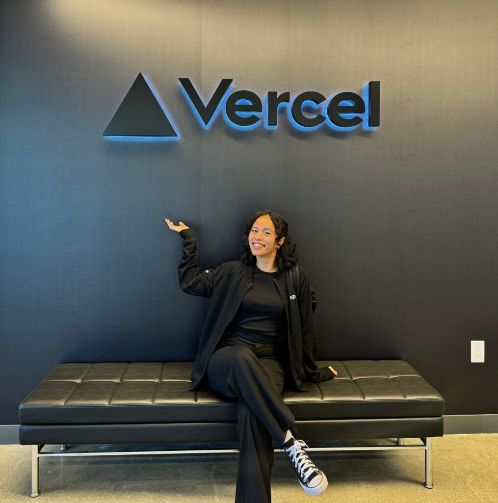 Pauline under the "Vercel" logo in the office