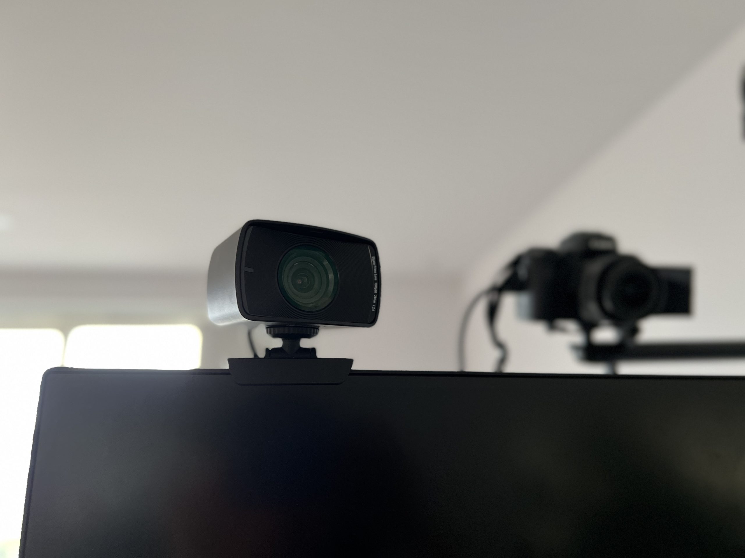 Elgato’s Facecam webcam with the DSLR webcam in the background